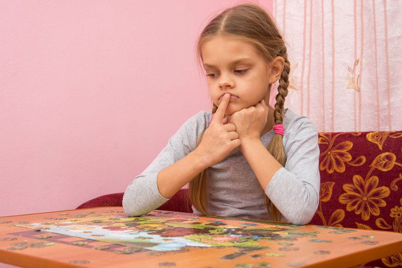 Child trying to figure out a puzzle
